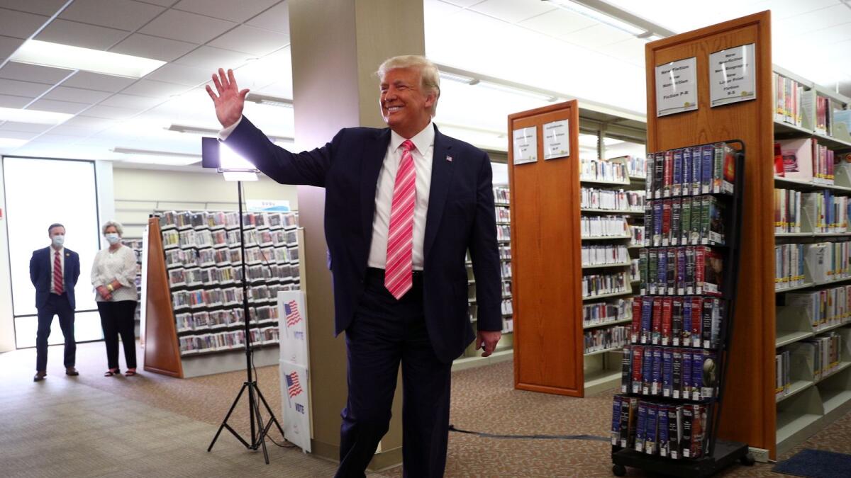 US President Donald Trump waves after voting in the 2020 presidential election at the Palm Beach County Library in West Palm Beach, US, on Saturday.