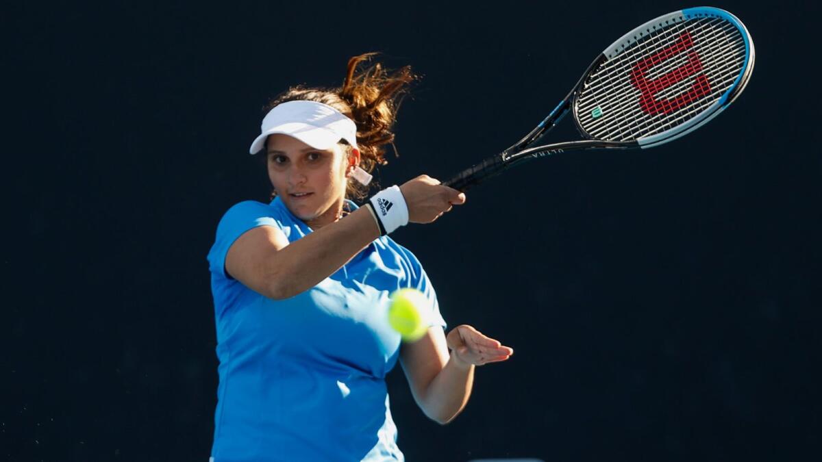 India's Sania Mirza hits a return as she plays with partner Rajeev Ram of the US against Serbia's Aleksandra Krunic and Nikola Cacic during their mixed doubles match on day four of the Australian Open tennis tournament in Melbourne on January 20, 2022. (Photo: AFP)