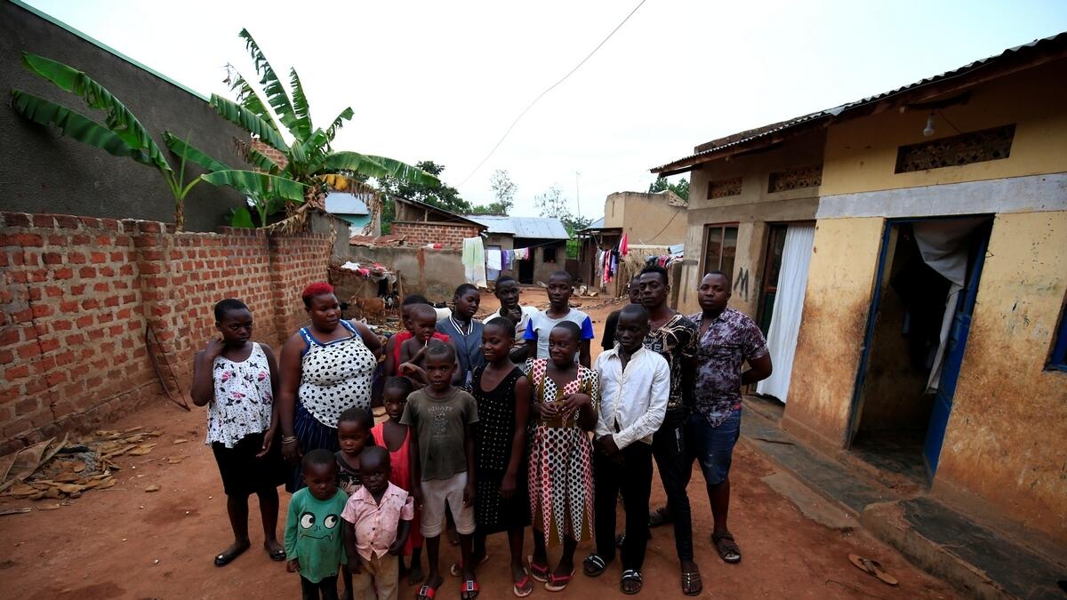 Mariam Nabatanzi, 39, (red hair) a mother of 38 children, takes a family portrait with some of her children at their home in Kasawo village, Mukono district, east of Kampala, Uganda- Reuters