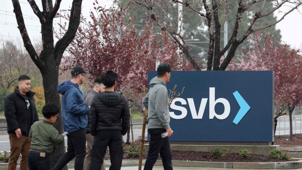 People walk through the parking lot at the Silicon Valley Bank (SVB) headquarters on March 10, 2023 in Santa Clara, California.- AFP