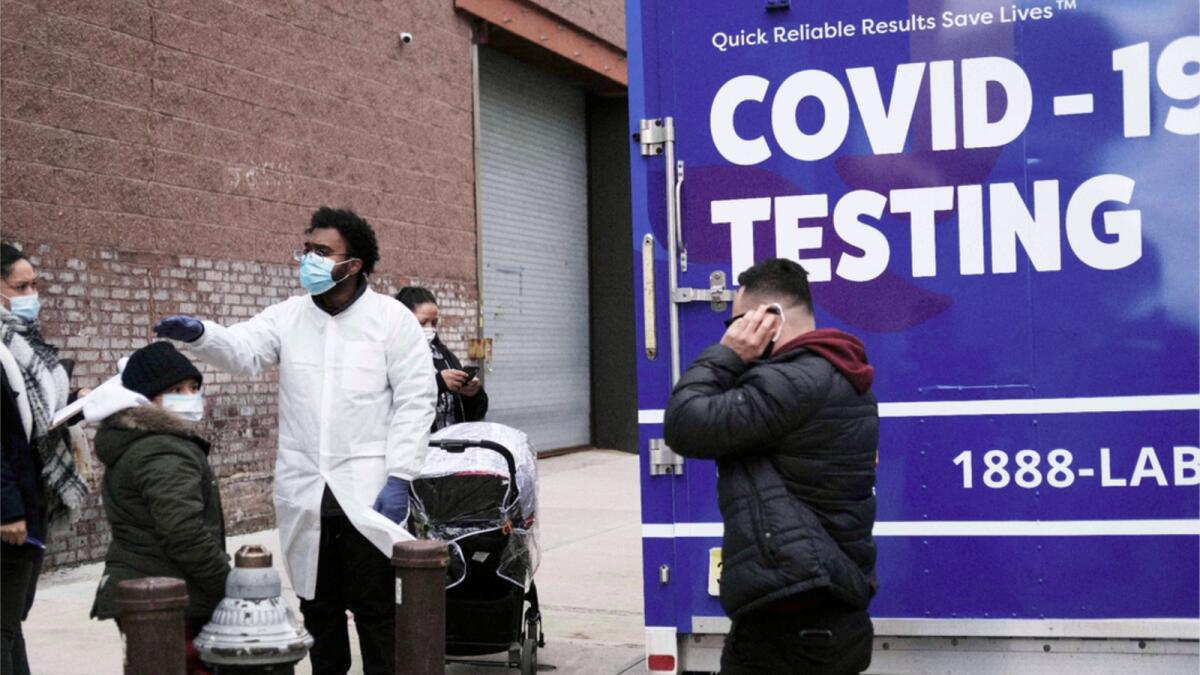 A medical worker stands outside of a mobile Covid-19 testing lab in Brooklyn. — AFP