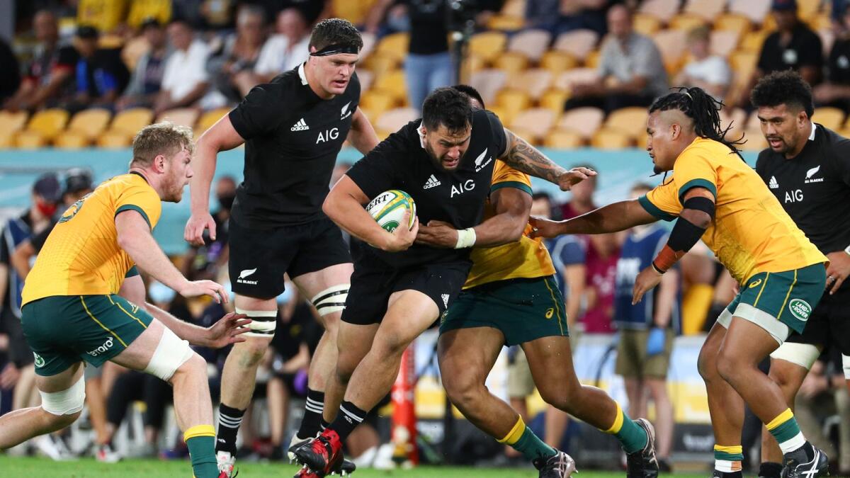 New Zealand's Tyrel Lomax (centre) runs at the defence during the Bledisloe rugby test between Australia and New Zealand at Suncorp Stadium, Brisbane. — AP