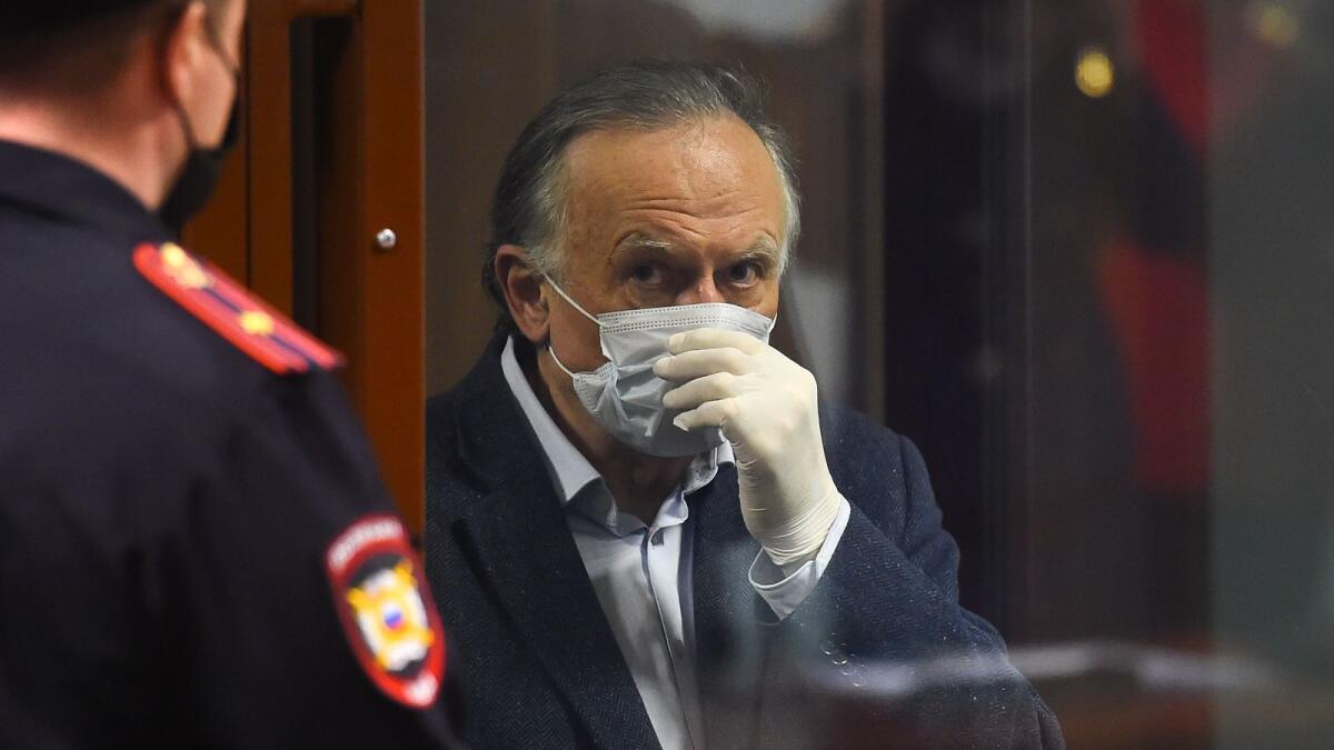 Russian historian Oleg Sokolov, accused of murdering and dismembering his former student lover, stands inside a defendants' cage during his verdict hearing in Saint Petersburg on Friday.