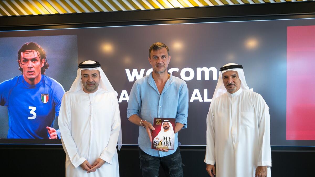Saeed Hareb (right) presents Paolo Maldini with a copy of My Story, in the presence of Nasser Aman Al Rahma