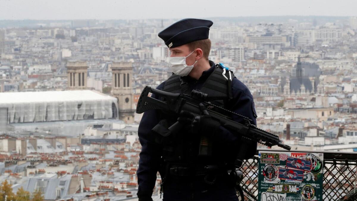 A French CRS riot policeman patrols in Montmartre in Paris as France has raised the security alert for French territory to the highest level after the knife attack in the city of Nice, France, October 30, 2020.