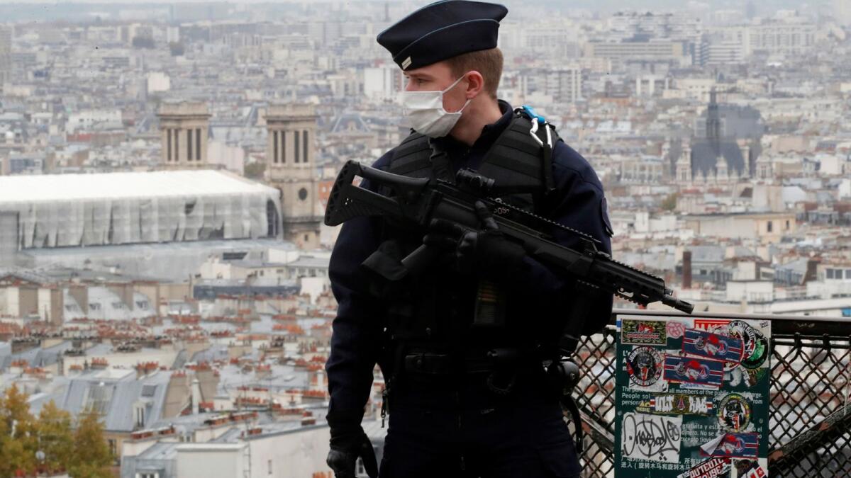 A French CRS riot policeman patrols in Montmartre in Paris as France has raised the security alert for French territory to the highest level after the knife attack in the city of Nice, France, October 30, 2020.