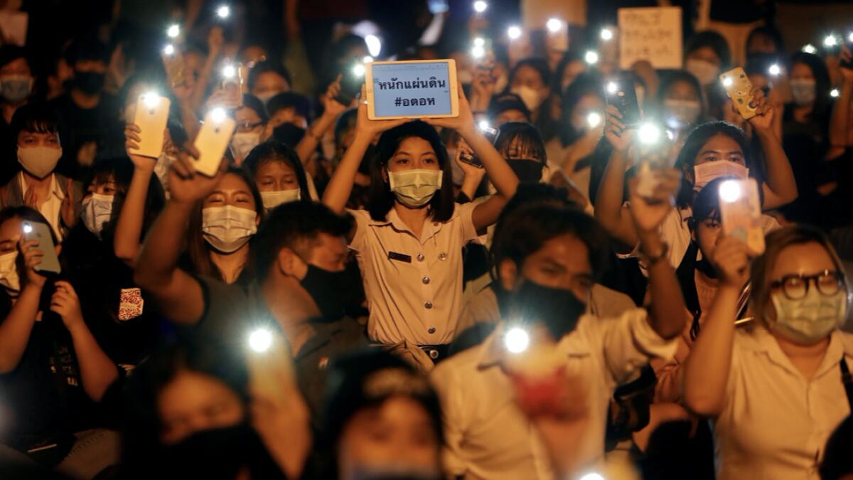 Demonstrators light up their smartphones as they gather during a protest demanding the resignation of Thailand's Prime Minister Prayut Chan-o-cha, under a highway in Pathum Thani, at the outskirts of Bangkok, Thailand. Photo: Reuters
