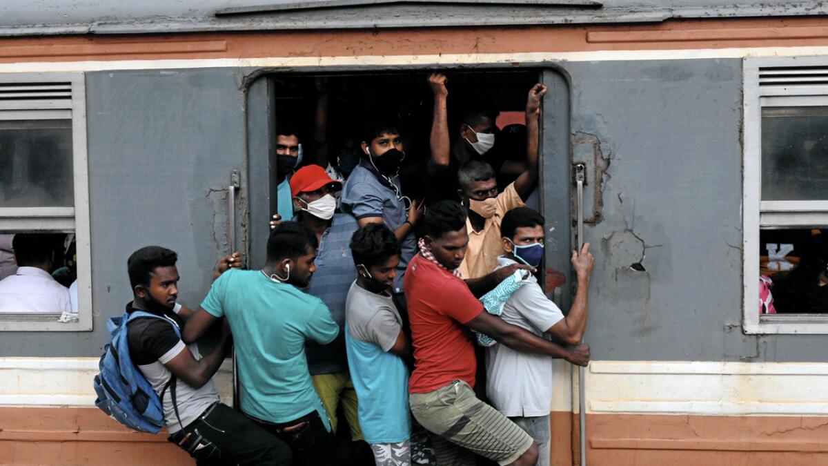 Passengers wearing protective masks travel on an overcrowded train towards capital city, amid concerns about the spread of the coronavirus disease (Covid-19), in Colombo, Sri Lanka. Photo: Reuters