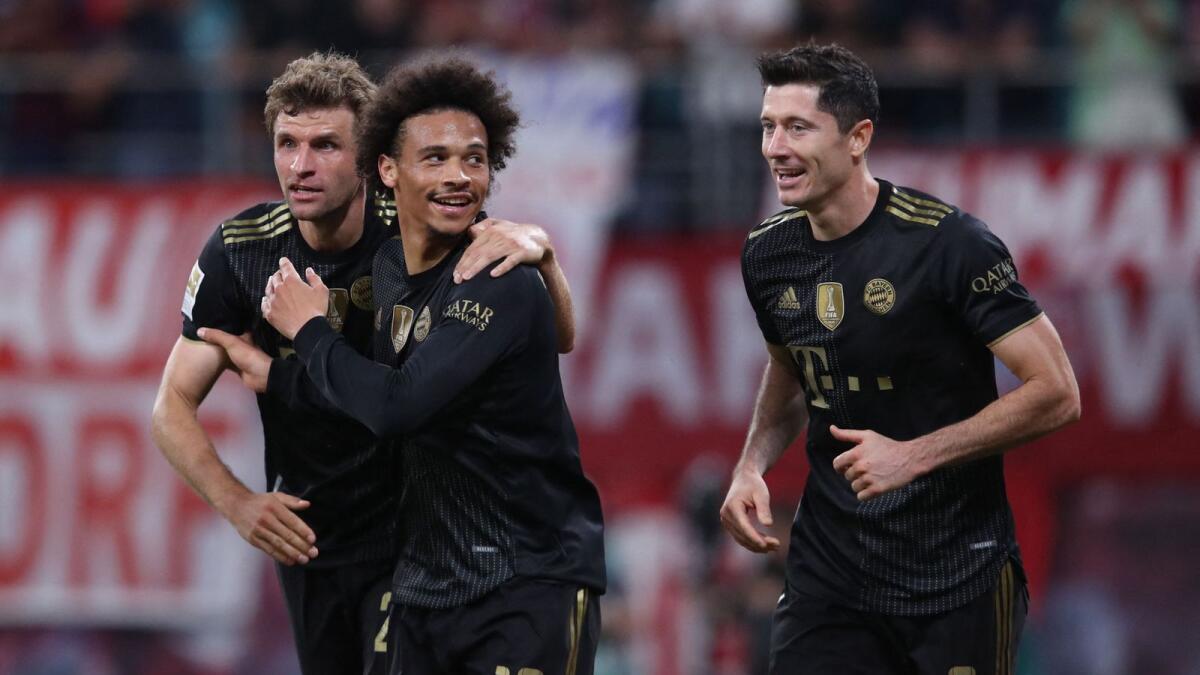 (Left to right) Bayern Munich's Thomas Mueller, Leroy Sane and Robert Lewandowski celebrate victory over RB Leipzig.— AFP