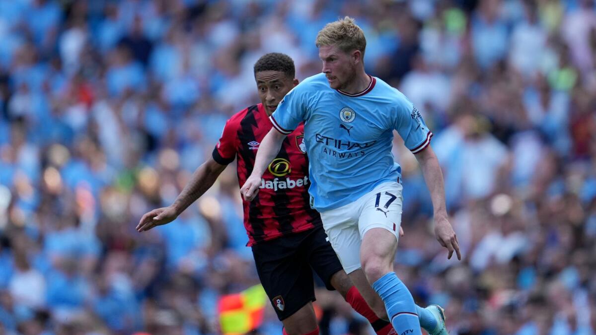 Manchester City's Kevin De Bruyne (right) duels for the ball with Bournemouth's Marcus Tavernier during the English Premier League match at Etihad stadium in Manchester on Saturday. — AP