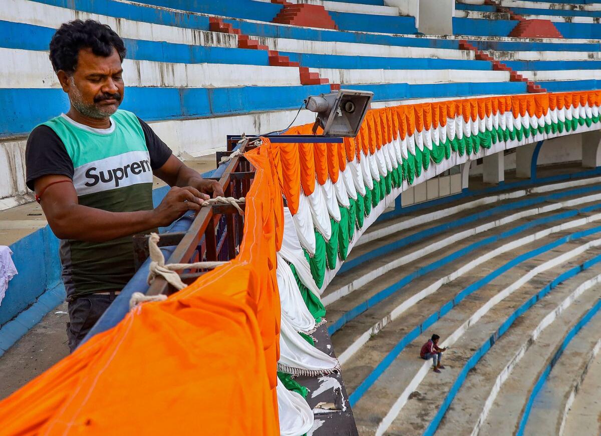 Preparations for the oath-taking ceremony of Karnataka chief mnister being stopped and arrangements being removed at the Sree Kanteerava Stadium in Bengaluru on Wednesday. Photo: PTI