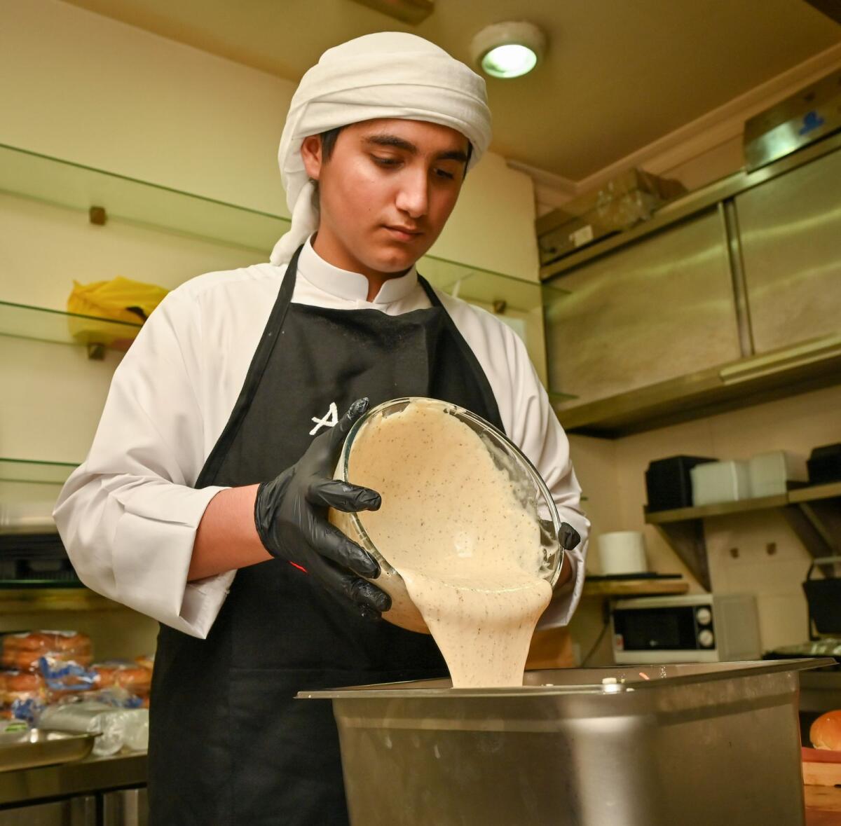 Abdulla AlJanahi works in his kitchen in Dubai. — Photo by M Sajjad