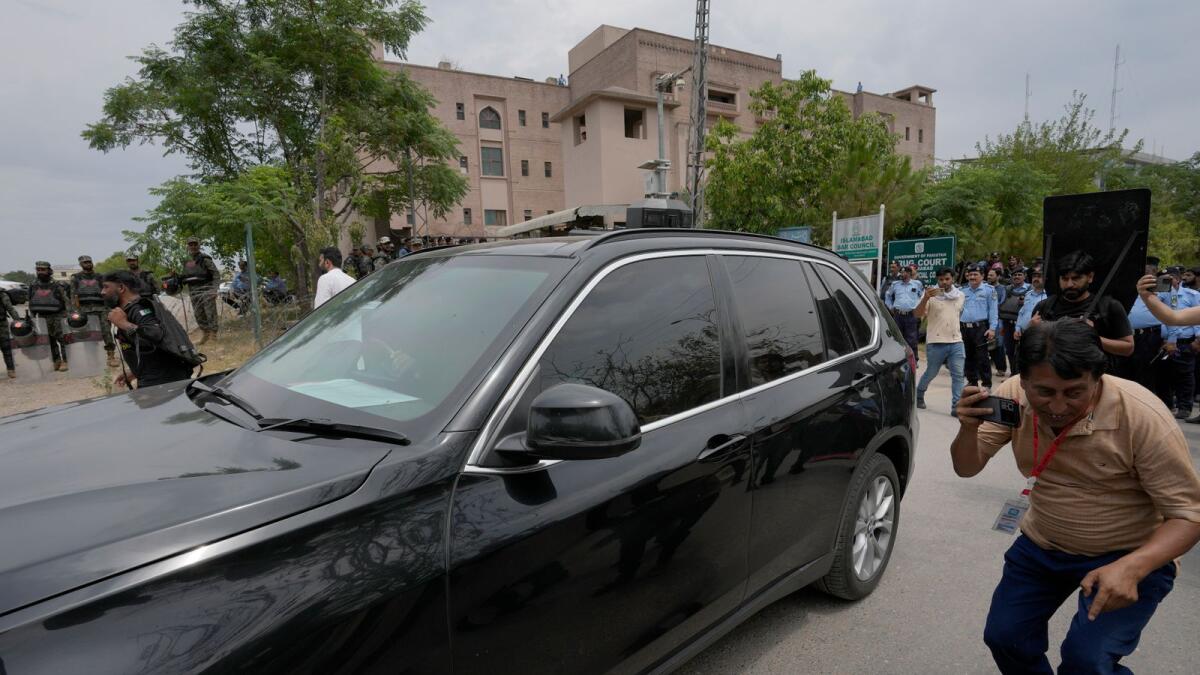 A vehicle carrying the Pakistan's former prime minister Imran Khan leaves after his court appearance in Islamabad on Tuesday. — AP
