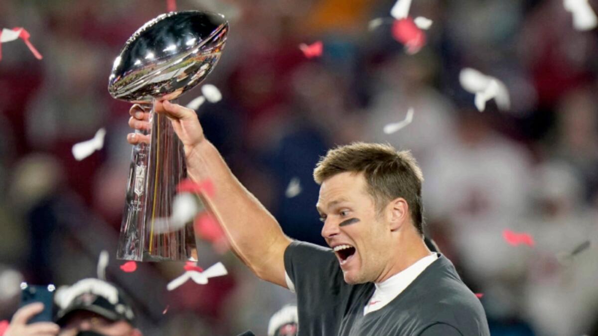 Tampa Bay Buccaneers quarterback Tom Brady celebrates with the Vince Lombardi Trophy after the NFL Super Bowl. — AP