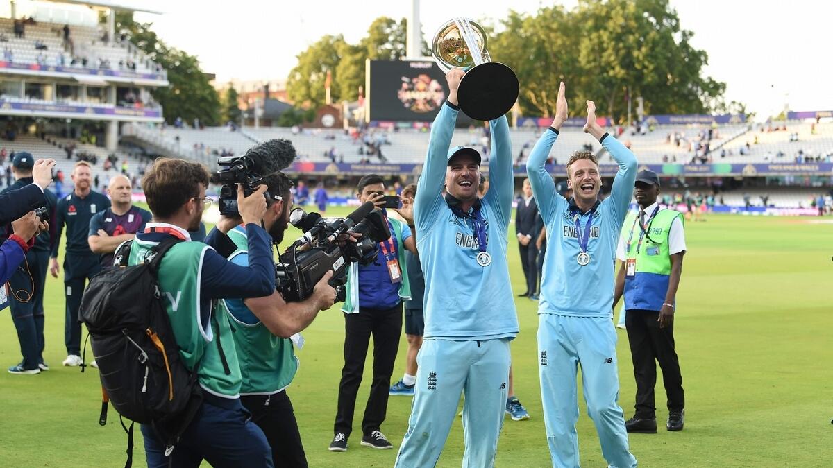 England's Jason Roy celebrates with the World Cup trophy on the pitch after the 2019 Cricket World Cup final between England and New Zealand at Lord's Cricket Ground. AFP