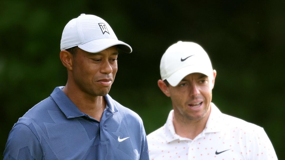 Rory McIlroy (right) of Northern Ireland and Tiger Woods of the United States wait on the first tee during the third round of The Northern Trust
