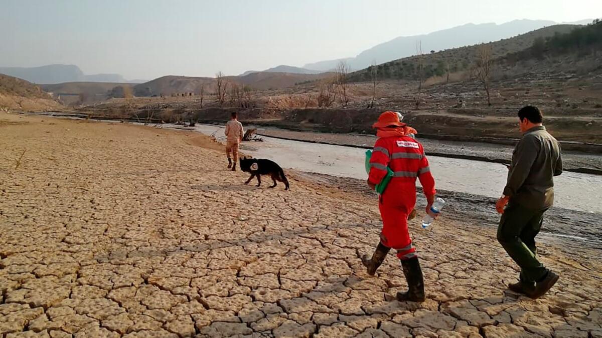 Iranian Red Crescent Society rescue team search for missing people in Fars province. –AP