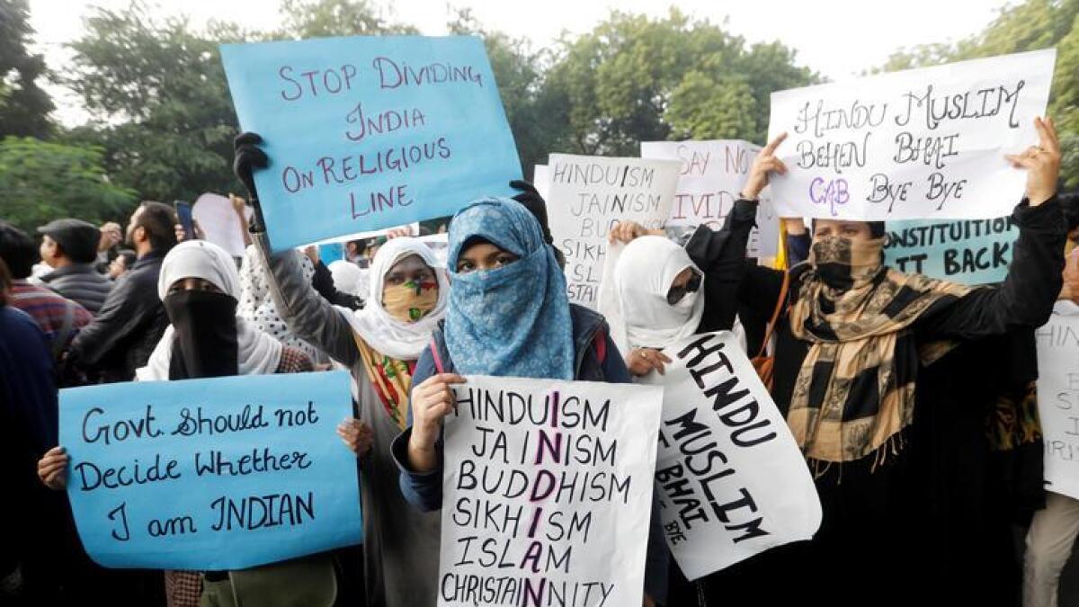 Protesters hold placards during a protest against the Citizenship Amendment Bill, that seeks to give citizenship to religious minorities persecuted in neighbouring Muslim countries, in New Delhi. Reuters