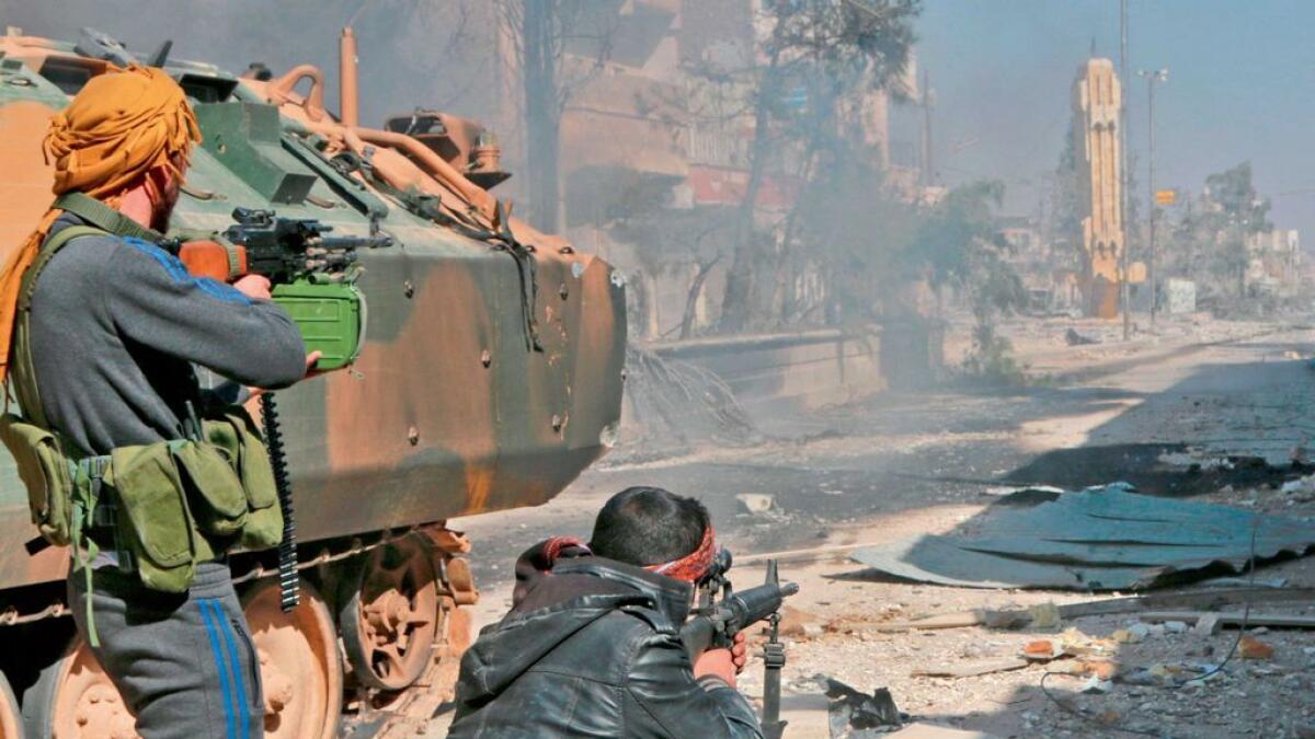 Syrian opposition fighters take position during their advance in the city of Al Bab, some 30 kilometres from Aleppo. 