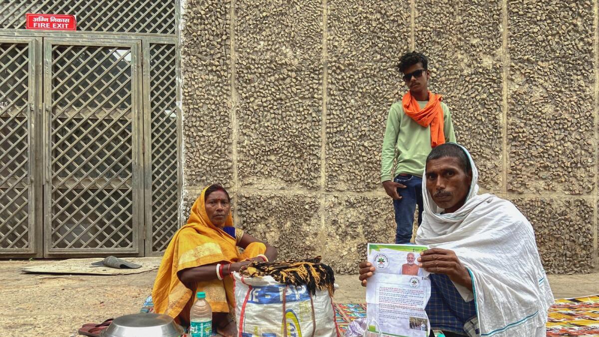 Shubha Devi, 45, a heart patient, and her husband Dwarka Rajvanshi wait for an appointment outside the building of All India Institute of Medical Sciences in New Delhi on May 1, 2023. Photo: Reuters