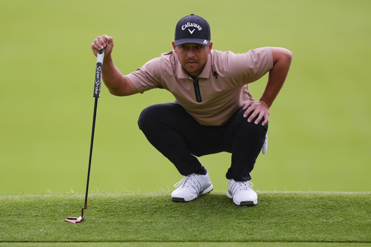 Xander Schauffele lines up a putt during the final round of the Genesis Invitational golf tournament at Riviera Country Club, in the Pacific Palisades area of, Los Angeles. - AP
