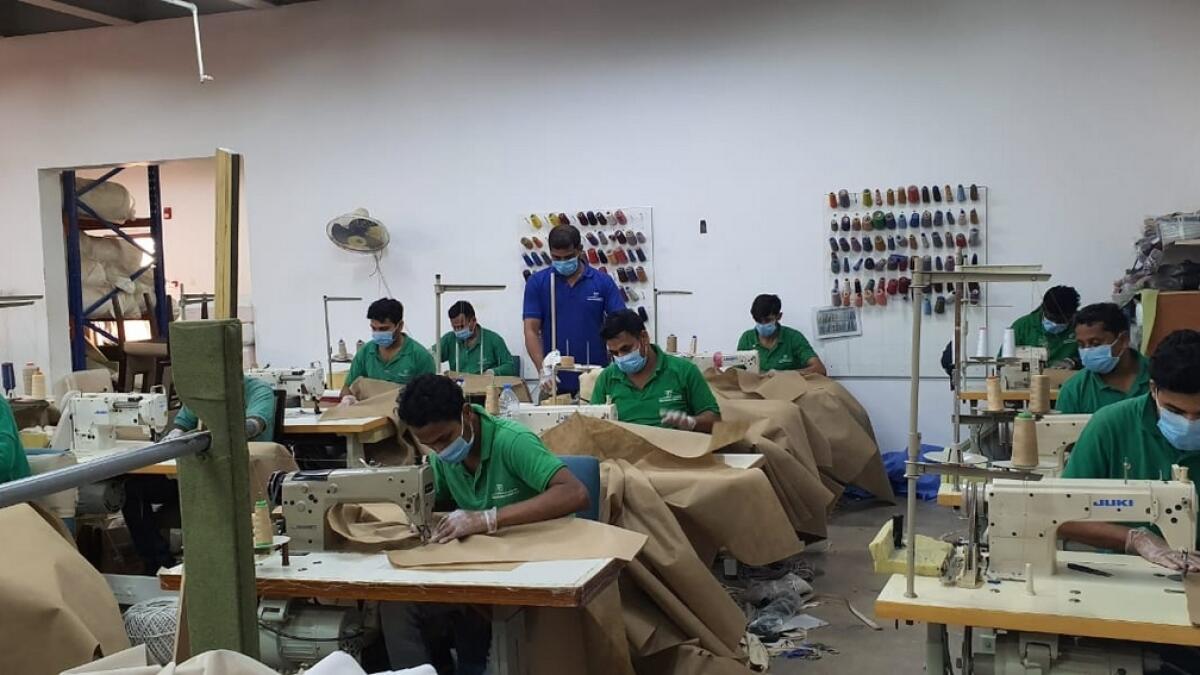 Combating, Covid-19, Sharjah, furniture manufacturer, produces, 150 hospital gowns, per day, free,