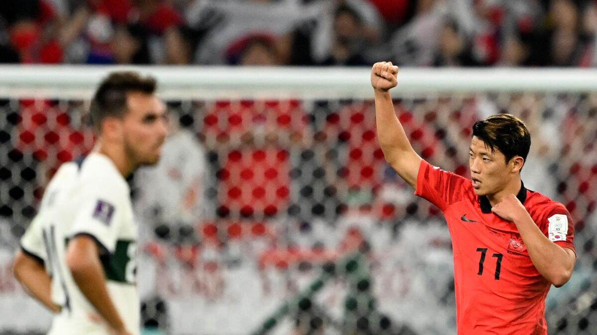 South Korea's midfielder Hwang Hee-chan celebrates scoring his team's second goal during the Qatar 2022 World Cup Group H match with Portugal. –AFP