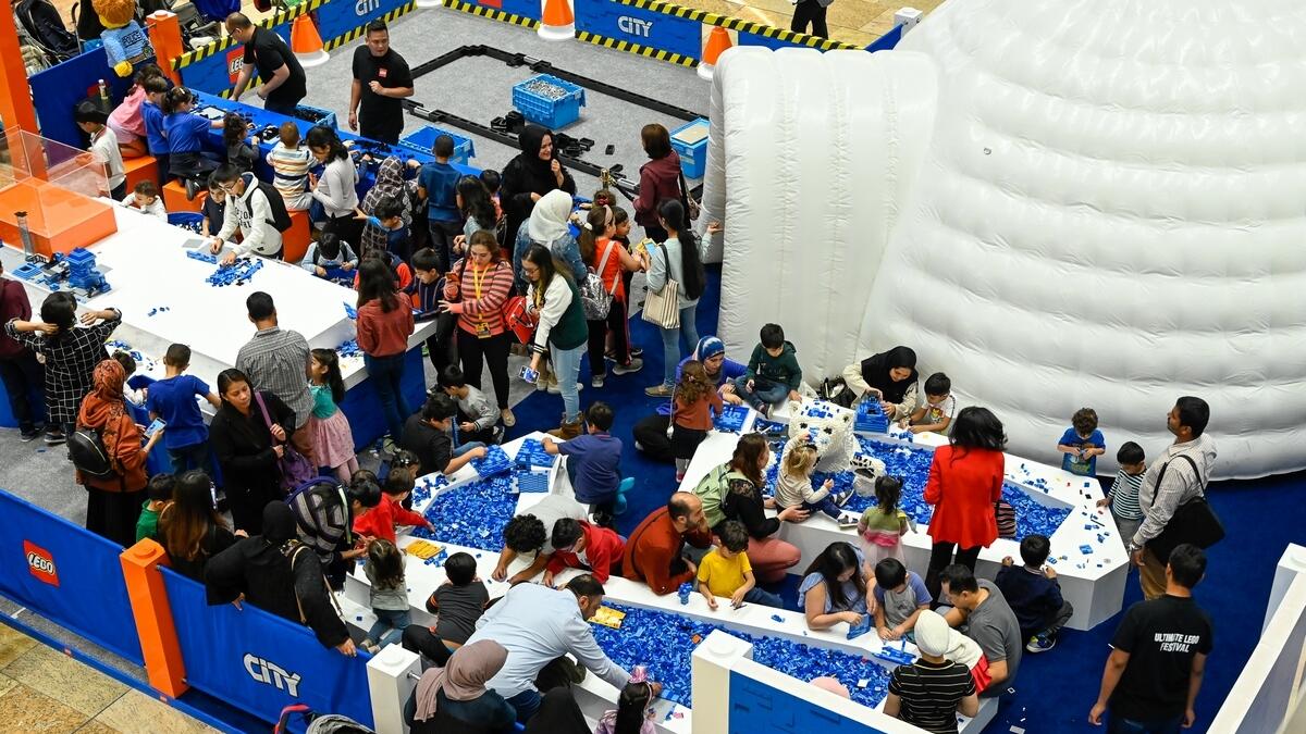 Families and kids at one of the Lego stations.