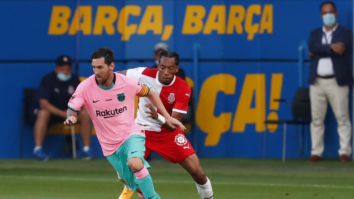 Barcelona's Lionel Messi (left) vies for the ball with Girona's Mojica during the pre-season friendly. (AP)