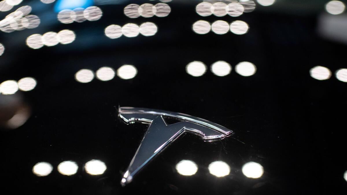 (FILES) In this file photo taken on May 26, 2021 a Tesla logo is seen on a Tesla car Model 3, inside of a Tesla shop inside of a shopping Mall in Beijing. Photo: AFP