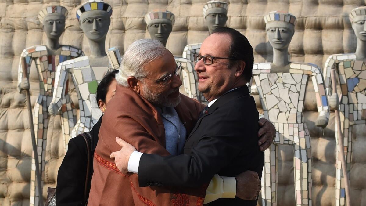 Indian Prime Minister Narendra Modi hugs France's President Francois Hollande (R) during their visit to the Rock Garden in Chandigarh.
