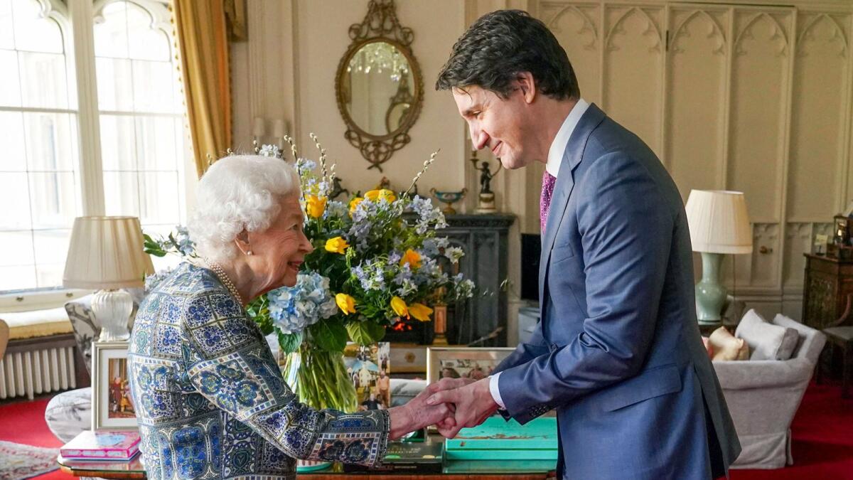 Britain's Queen Elizabeth II shakes hands with Canadian Prime Minister Justin Trudeau as they meet for an audience at the Windsor Castle, Berkshire, on March 7, 2022. —AFP 