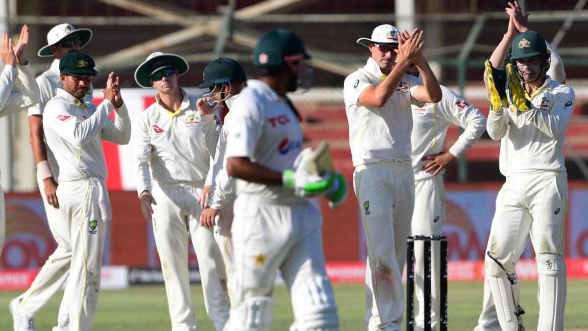 Australia's cricketers applaud as Pakistan's captain Babar Azam walks back to the pavillon after a brilliant innings at the National Cricket Stadium in Karachi — AFP