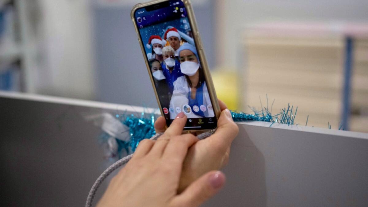 Hospital worker Houda Mokrani takes a selfie with her colleagues on Christmas day in the Covid-19 intensive care unit at the la Timone hospital in Marseille, southern France. — AP