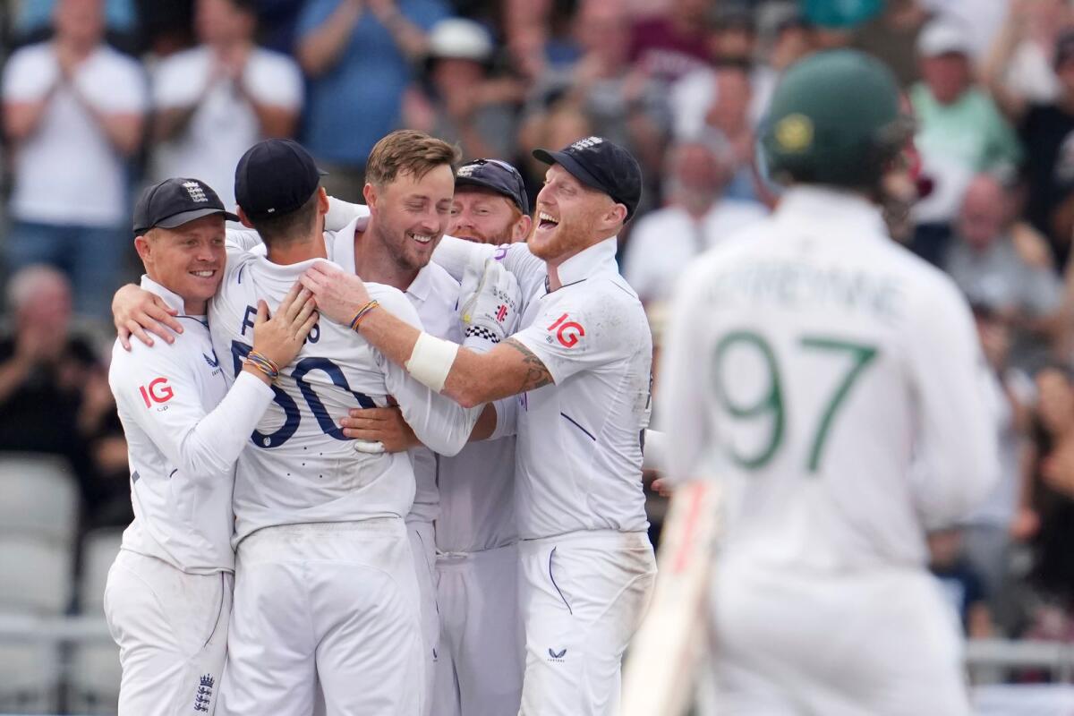 England's Ollie Robinson (centre) celebrates with teammates after the dismissal of South Africa's Lungi Ngidi. (AP)
