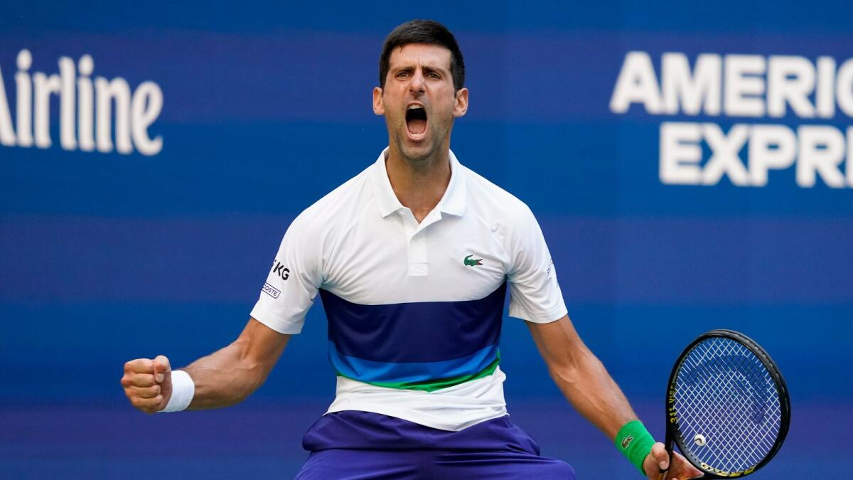 Novak Djokovic reacts after scoring a point against Kei Nishikori during the third round of the US Open tennis championships. — AP