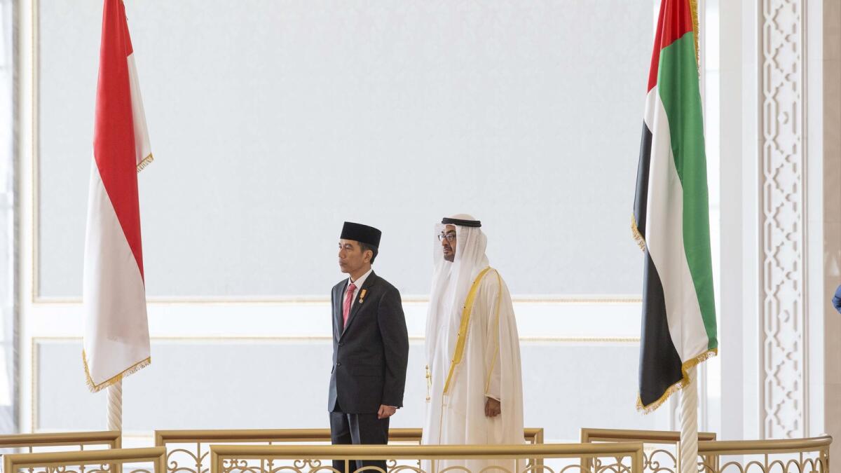 His Highness Shaikh Mohammed bin Zayed Al Nahyan, Crown Prince of Abu Dhabi and Deputy Supreme Commander of the UAE Armed Forces (R), and Joko Widodo President of the Republic of Indonesia (L), stand for the UAE National Anthem during an official reception held at the Presidential Airport.