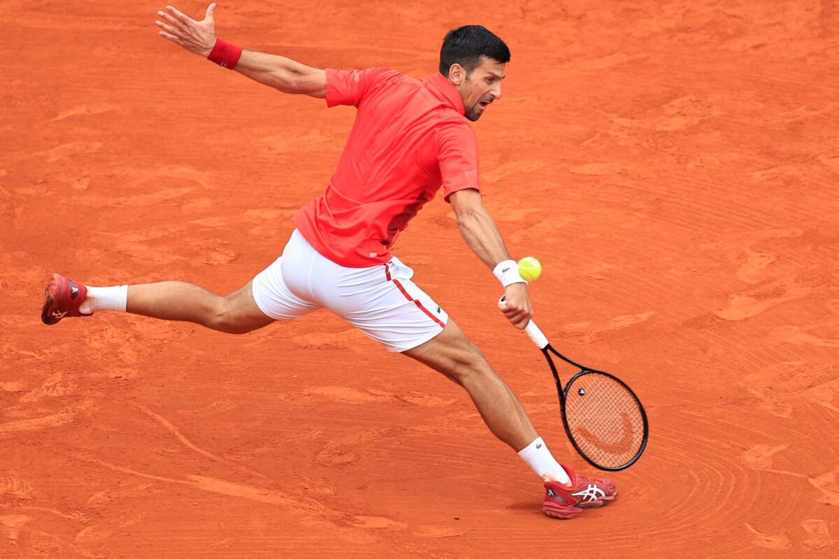 Serbia's Novak Djokovic plays a backhand return to Russia's Roman Safiullin. — AFP