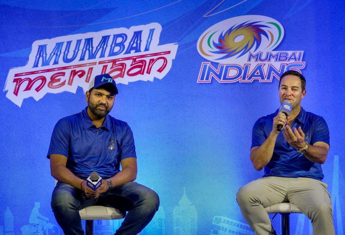 Mumbai Indians coach Mark Boucher (right) speaks as captain Rohit Sharma looks on in Mumbai on Wednesday. — PTI