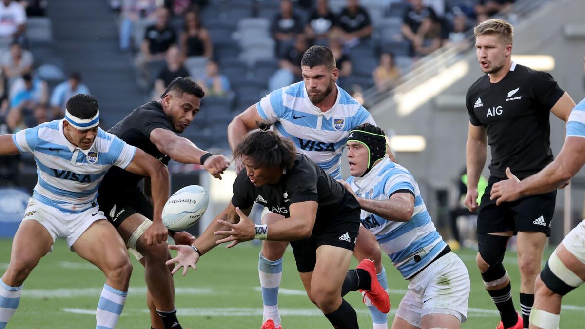 Argentina's Matias Alemanno (second right) tackles New Zealand's Caleb Clarke (centre) during the 2020 Tri-Nations rugby match. — AFP