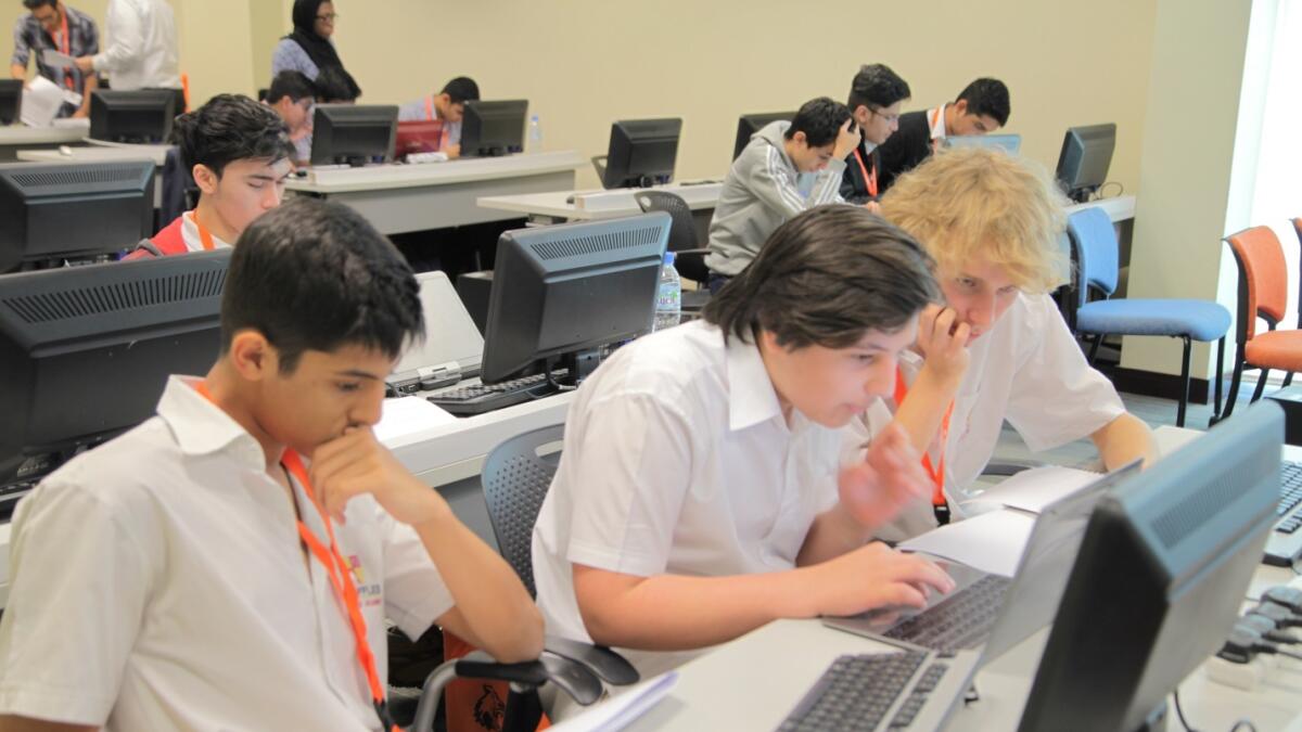 Hard at work to win the contest, and (right) the team from GEMS Wellington, Silicon Oasis, Dubai, winners in the computing competition. — Supplied photos