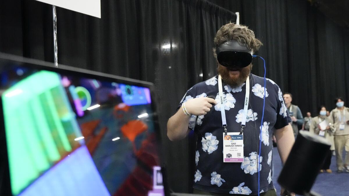 Gad Baruch Hinkis, of PatchXR, demonstrates the PatchWorld program. PatchWorld is an augmented reality gaming platform that allows users to create virtual building blocks for music. — AP