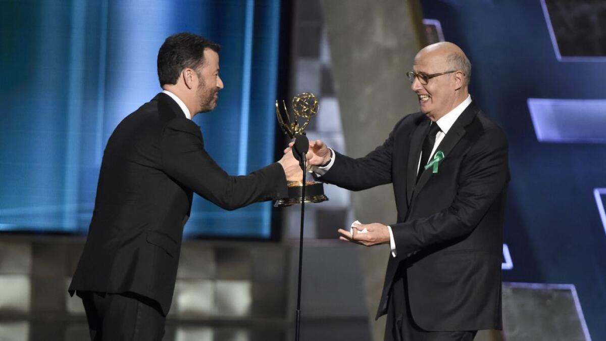Jimmy Kimmel, left, presents the award for outstanding lead actor in a comedy series to Jeffrey Tambor for 'Transparent' at the 67th Primetime Emmy Awards.