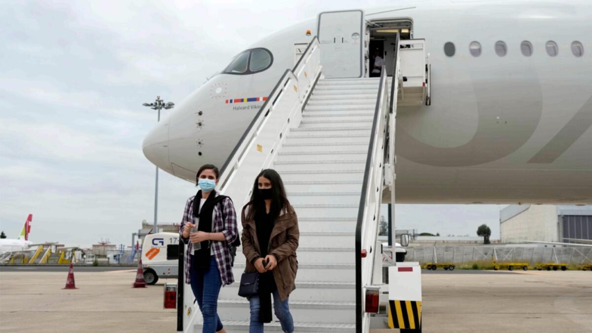 Afghan musicians Shogofa Safi and Marzia Anwari disembark from a plane at Lisbon military airport. — AP
