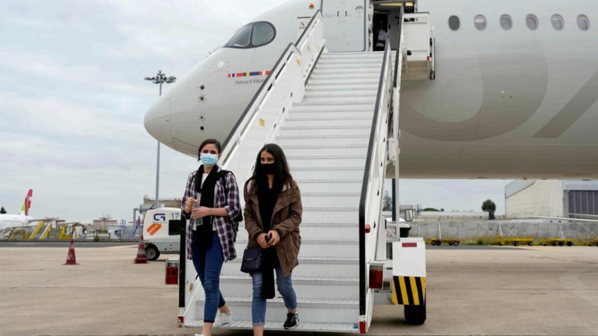 Afghan musicians Shogofa Safi and Marzia Anwari disembark from a plane at Lisbon military airport. — AP