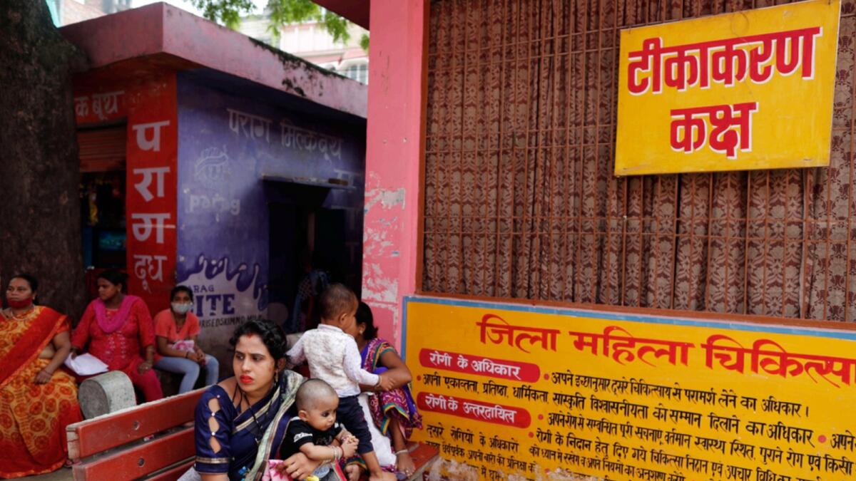 People wait for their turn to receive Covid vaccine at District Govt Women's Hospital in Varanasi. — AP