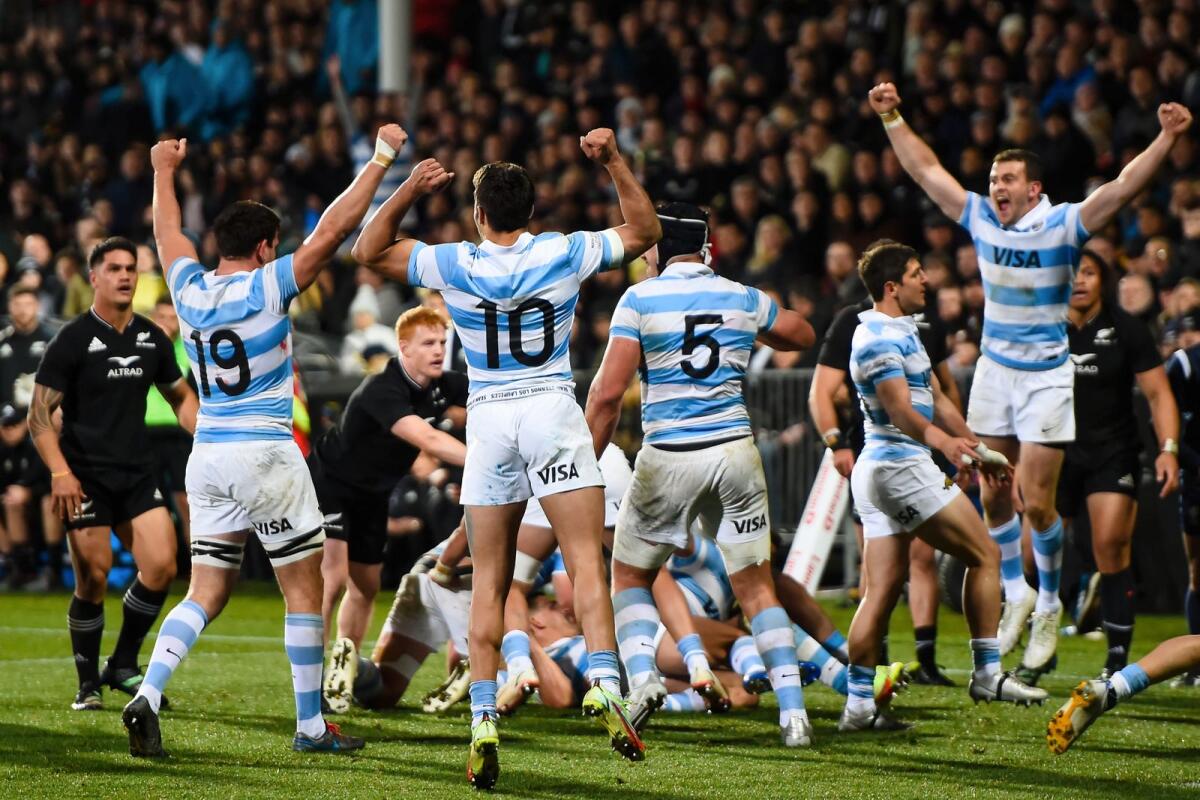 Argentina players celebrate their victory over New Zealand in Christchurch, New Zealand, on Saturday. (AP)