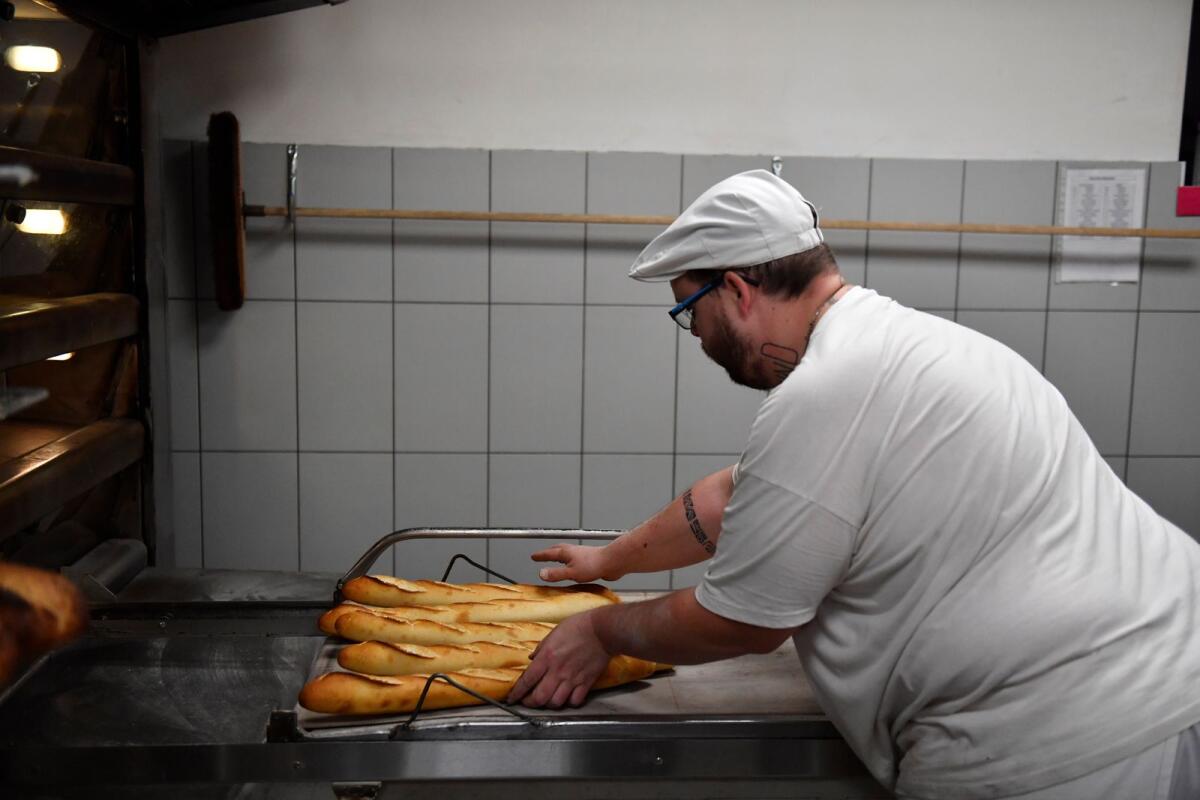 A baker prepares loaves of Baguette bread in a bakery in Brou near Chartres, southwest of Paris, on December 1. Photo: AFP