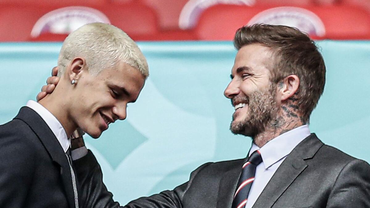 Romeo Beckham and David Beckham. — Twitter