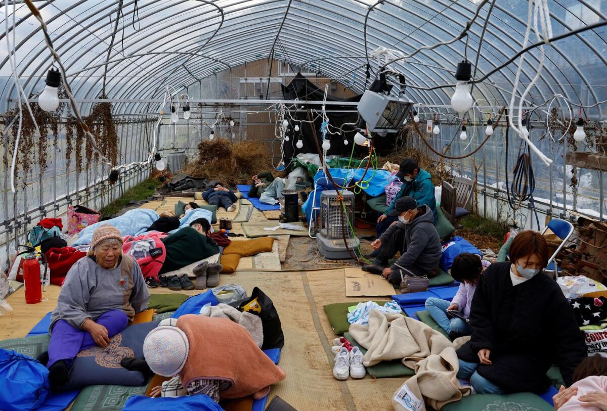 Evacuated people rest at a green house converted as an evacuation centre in the aftermath of an earthquake  in Wajima, Ishikawa prefecture, Japan, on Tuesday. — Reuters